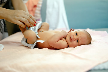 Parent changing newborn's diapers