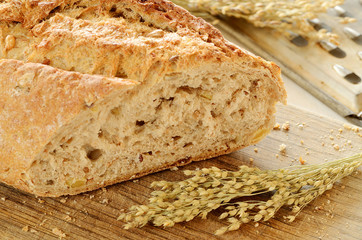Close-up of fresh wheat bread  on wooden cutting board