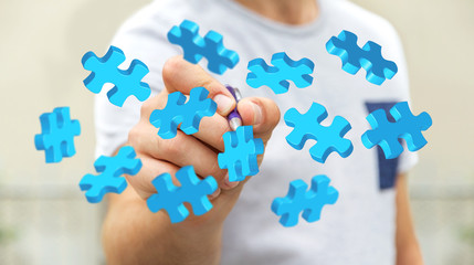 Businessman touching flying puzzle pieces ‘3D rendering’