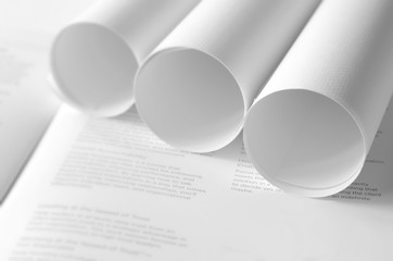 Roll of white papers on journal page,black and white concept.