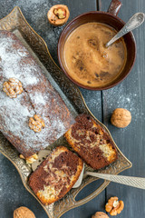 Homemade chocolate cake with nuts and a cup of coffee.