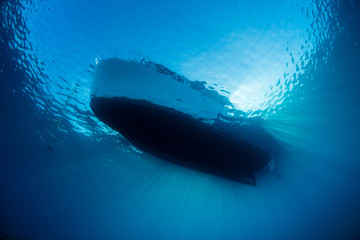 Small Boat Floating in Tropical Water