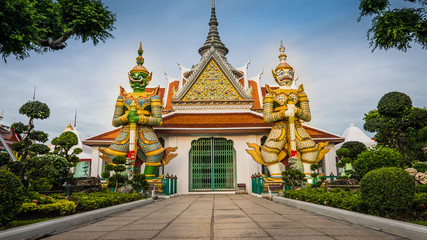 Demon Guardian statues decorating the Buddhist temple Wat Arun in Bangkok, Thailand