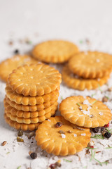 Salted crackers on white wood background