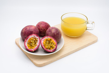 passion fruit juice with passion fruit in a cup on a wooden plat