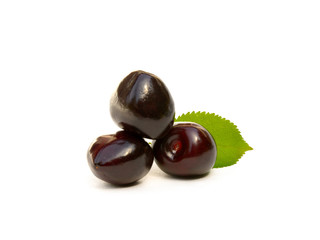 Sweet ripe cherries with leaf isolated on white background