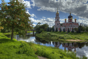 Fototapeta na wymiar Landscape with the Russian Church on the River Bank