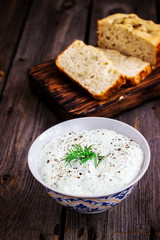 Multigrain bread,dill  and spiced yoghurt on rustic background.