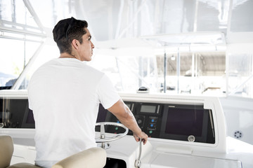 Young man driving a yacht