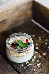 yogurt with berries and products for healthy breakfast, close-up
