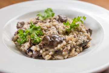 risotto with mushrooms on white palat, restaurant