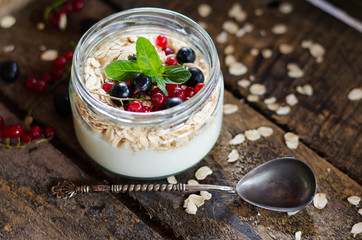 yogurt with berries and products for healthy breakfast, close-up
