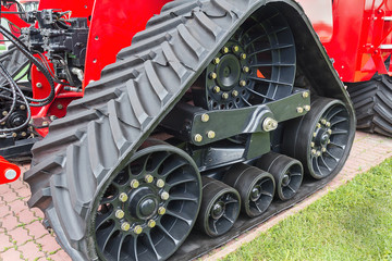 Rubber caterpillar farm tractor close up. Industry