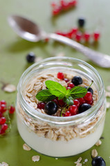 yogurt with berries and products for healthy breakfast, close-up
