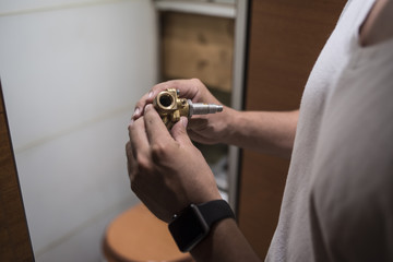 man repairing a boat bathroom