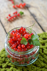 currants in glass jar on a wooden background