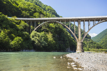 Landscape in Abkhazia with the stone bridge over river