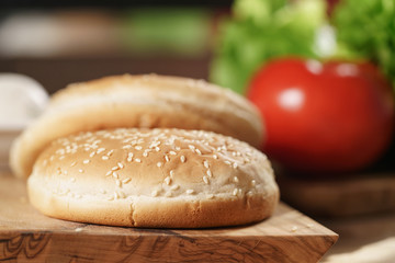 burger bun in front of other ingredients for burger