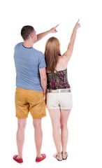 young couple in shorts and t-shirt pointing. Back view.  Rear view people collection.  backside view of person.  Isolated over white background.