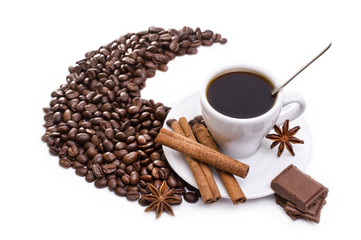 cup of coffee with cinnamon sticks, anise and chocolate