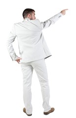 Businessman pointing at wall. rear view. Isolated over white . 