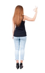 Back view of  woman thumbs up. Rear view people collection. backside view of person. Isolated over white background. slender redhead in a jeans shows the symbol of success or hitchhiking
