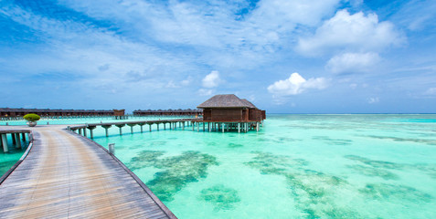 beach with water bungalows at Maldives