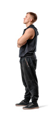 Side view of muscled young man standing with his arms folded looking up, isolated on white background