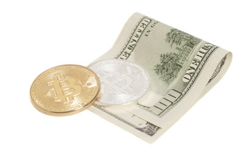 Golden and Silver bitcoin coins and one hundred dollar banknote