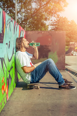 A young skater resting on his board © guruXOX