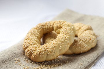 Fototapeta na wymiar Two homemade bagels with sesame on a gray canvas