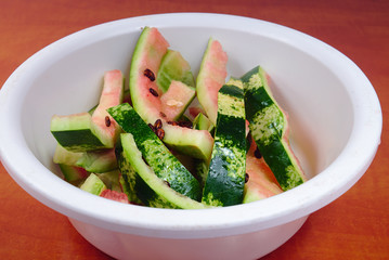 Scraps of watermelonein a white plastic bowl