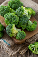 fresh broccoli on wooden surface