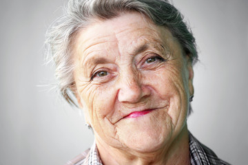 Smile granny face on a gray background