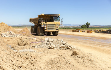 yellow dump truck on a construction site