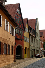 Obraz premium Traditional architecture in the old town of Dinkelsbuhl at sunset. It is one of the best-preserved medieval towns in Europe, part of the famous Romantic Road.