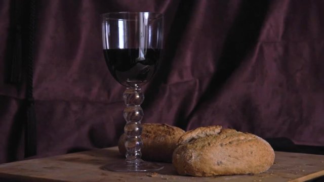 Glass of red wine and bread still life on dutch master canvas background