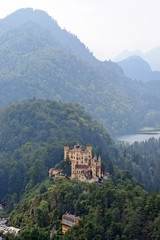 Fototapeta na wymiar View of Hohenschwangau Castle in a summer misty day near the lake Alpsee in Bavaria, Germany.