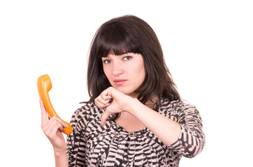 beautiful young woman using retro orange telephone