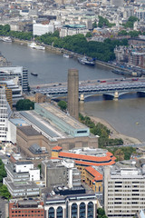 Fototapeta premium Tate Modern art gallery and Blackfriars Railway Bridge in London, United Kingdom from above. The latter is the largest of only two solar bridges in the world.