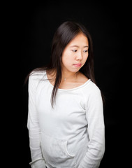 Obraz premium Portrait of Asian Teen Girl Posing on Black Background