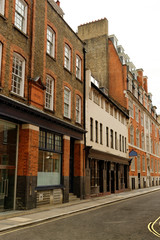 Fototapeta na wymiar Street with traditional red brick houses in central London, England.