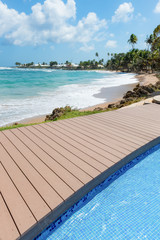 Tropical beach Tobago Caribbean nearby pool and wooden deck 