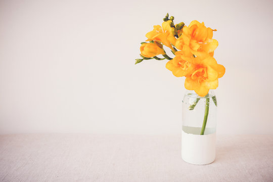 Yellow Freesia flowers in vase, Spring Easter background
