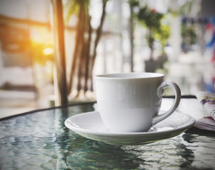 Coffee cup in Car Showroom, vintage style effect picture