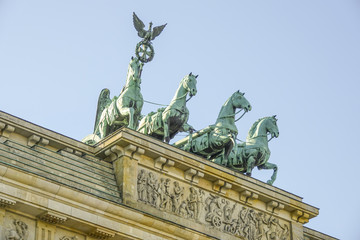 Fototapeta na wymiar Quadriga statue on famous Brandenburg gate in Berlin - Brandenburger Tor