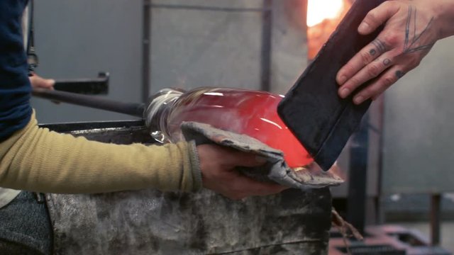 Blowing Glass - Using a wood paddle to protect against the heat