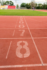 athletic track number on red rubber racetrack, texture of runnin