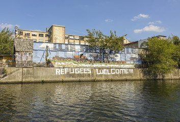 Refugees Welcome writing at the banks of River Spree in Berlin