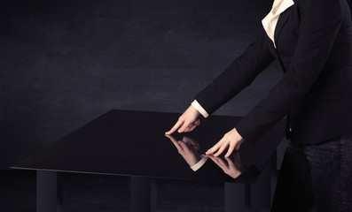 Close up of a hand touching smart table with copy space